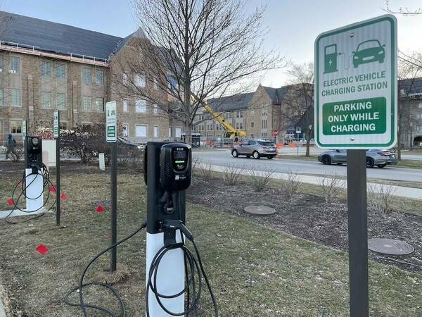 Picture of electric vehicle charging station with parking sign