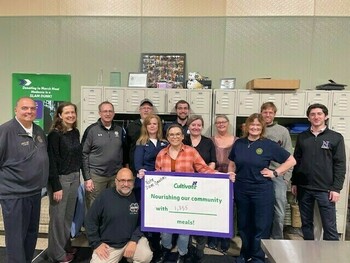 group photo of Notre Dame operations staff at Cultivate food rescue, with a sign that states they packed 1,355 meals.