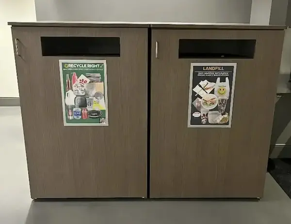 Two wood-grained waste bins. Left is "RECYCLE RIGHT" with recyclables; right is "LANDFILL" with food/non-recyclables.